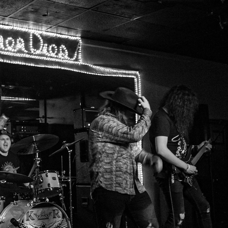 Band playing guitars and singing on stage in Augusta, GA