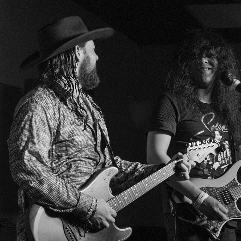 Band playing guitars and singing on stage in Augusta, GA