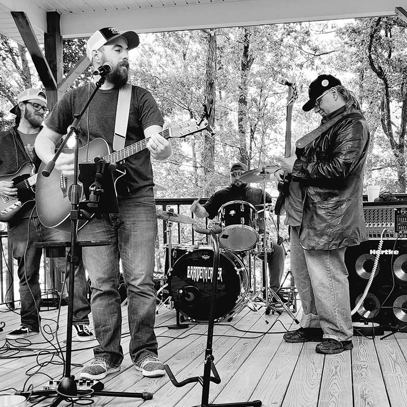 Band playing guitars and singing on stage in Augusta, GA